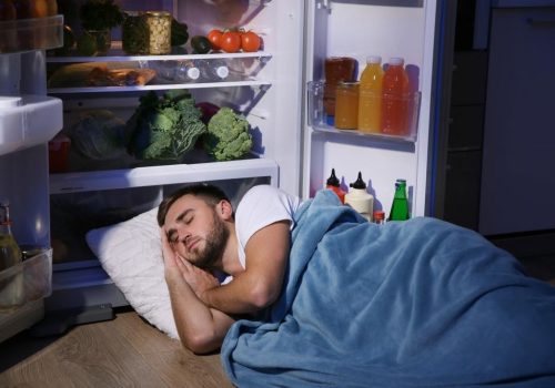 Man Asleep In Front Of Fridge